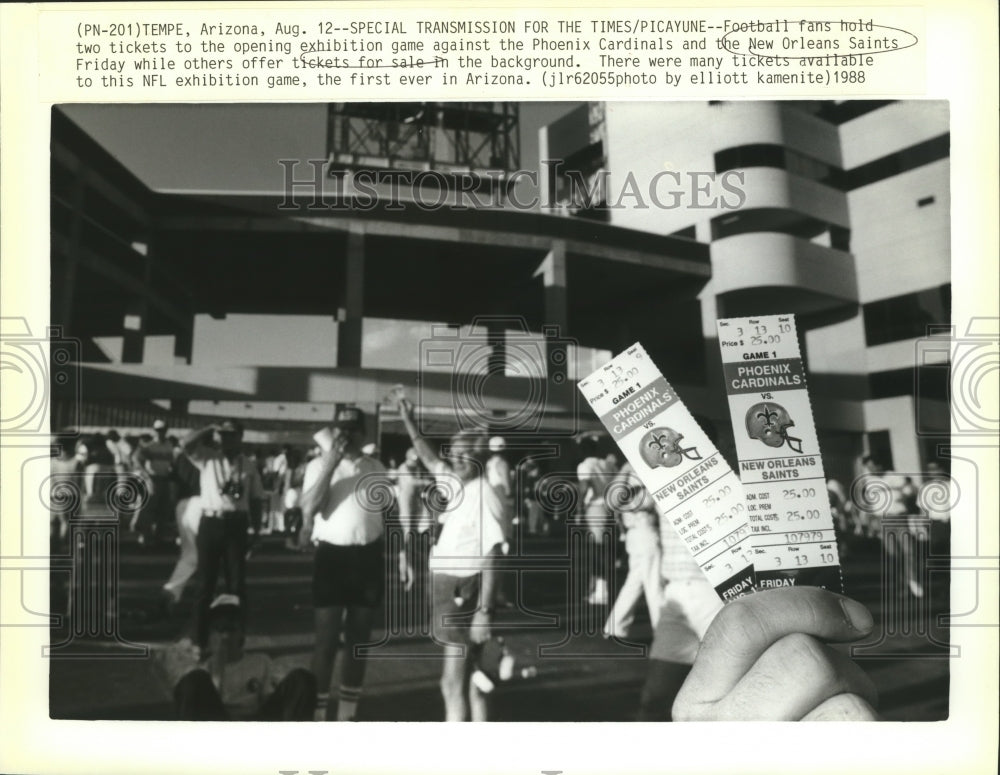 1988 Press Photo Football fans hold two tickets to the opening exhibition game- Historic Images