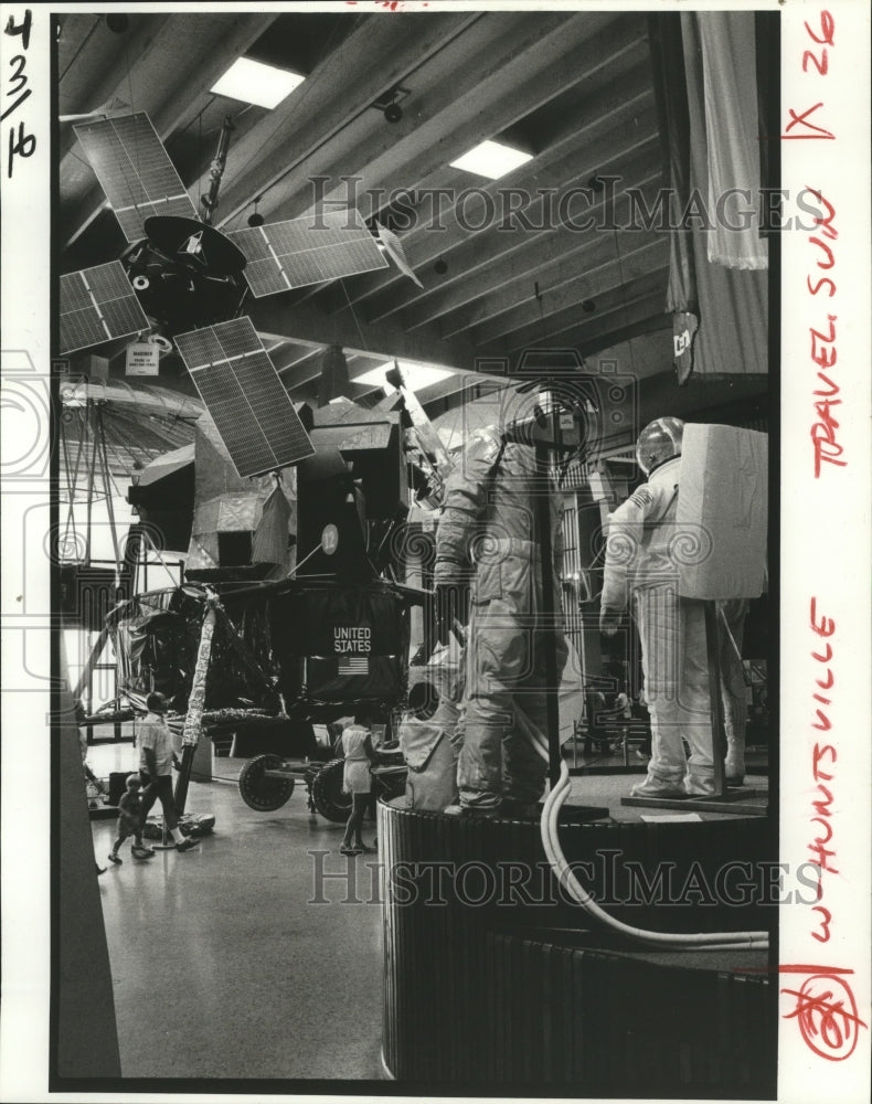 1985 Press Photo Satellites and space suits are on view at Alabama Space Center- Historic Images