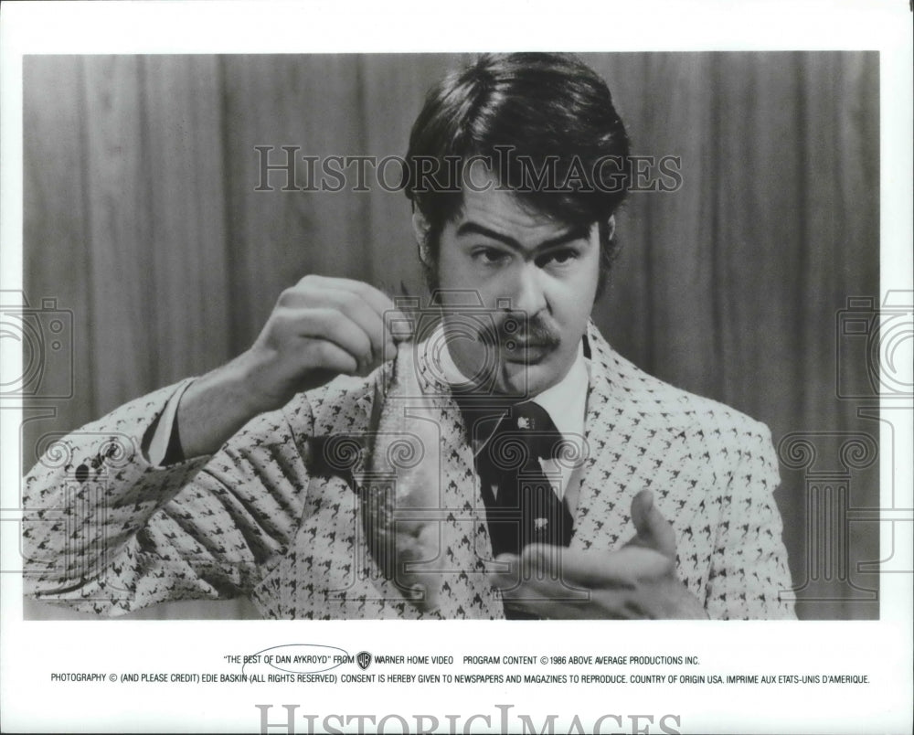 1986 Press Photo Man holds fish in &quot;The Best of Dan Aykroyd&quot; - Historic Images