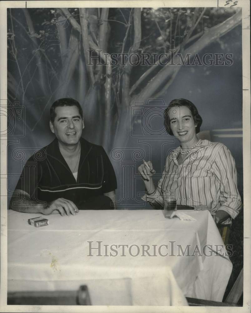 1957 Mr. &amp; Mrs. Richard Jaubert enjoy a smoke break - Historic Images