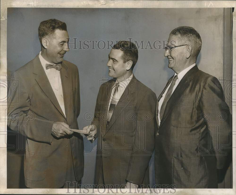 1955 Reginald Simpson presents a check to Louisiana Foundation reps. - Historic Images