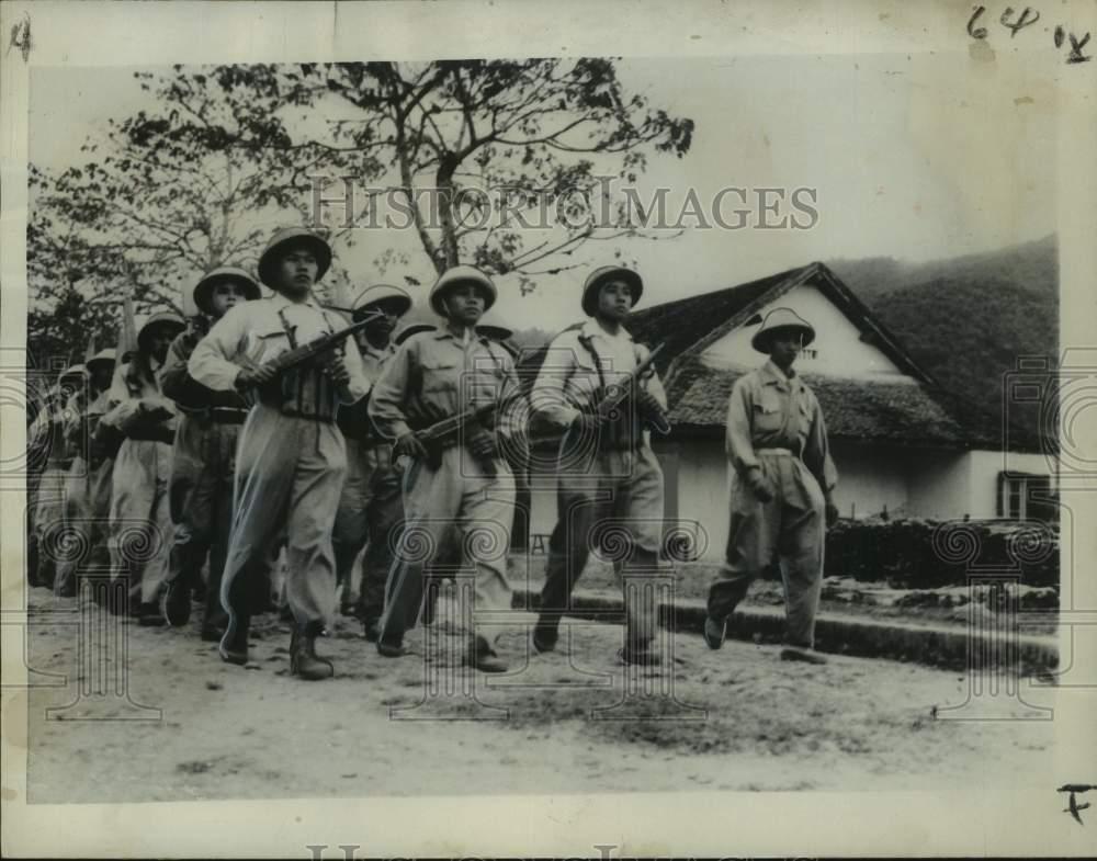 1961 Marching Pathet Lao troops in 1958 formed Communist forces.-Historic Images