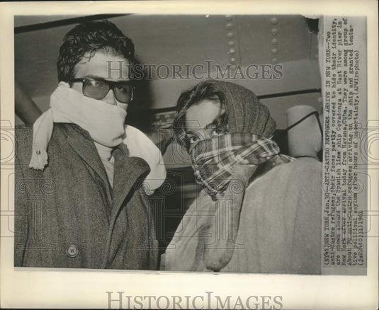 1961 Press Photo Two anti-Castro refugees with hidden faces, arrive in New York - Historic Images