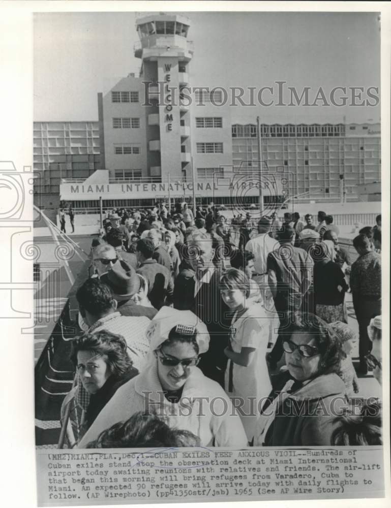 1965 Cuban refugees on observation deck at Miami wait for relatives. - Historic Images