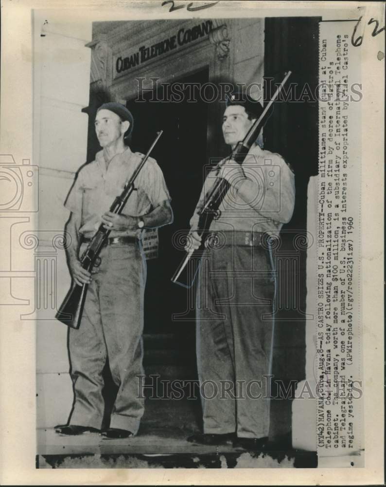 1960 Press Photo Militia stand guard at telephone company nationalized in Cuba. - Historic Images