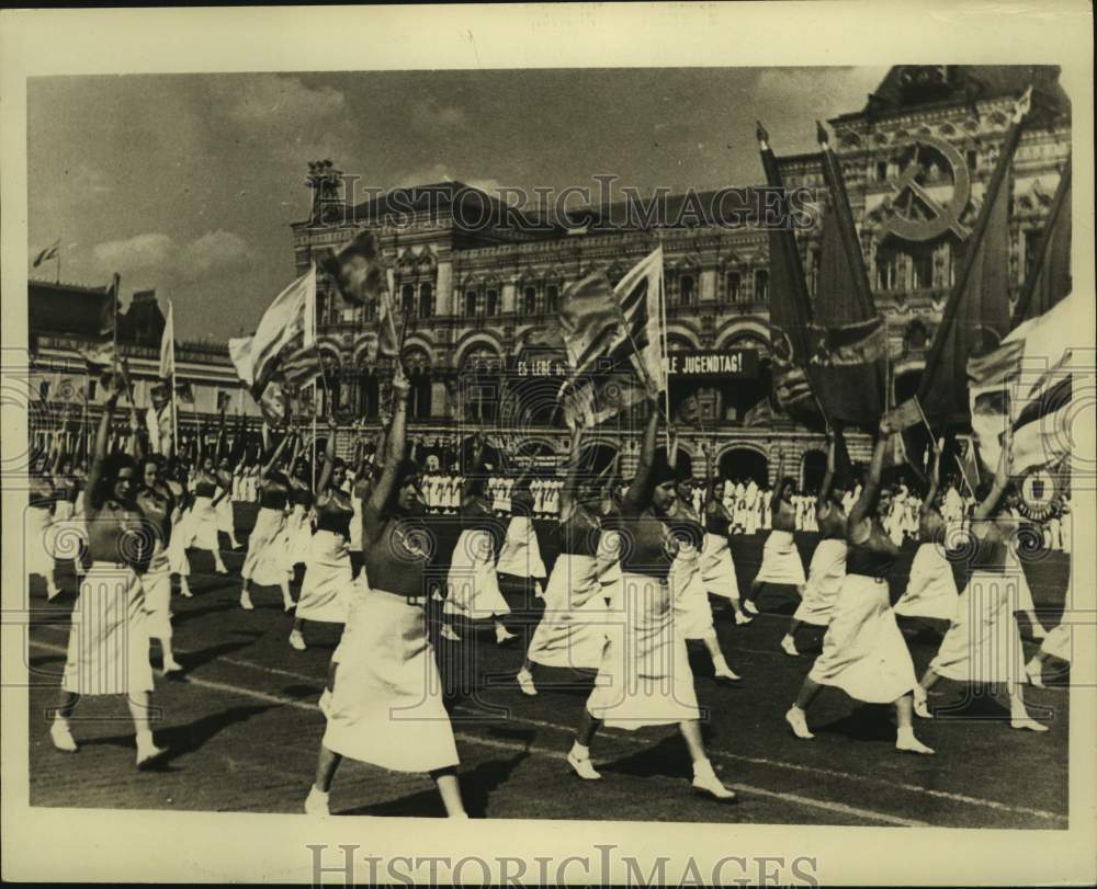 1937 Press Photo Russian girls parade red banners &amp; flags through Moscow - Historic Images