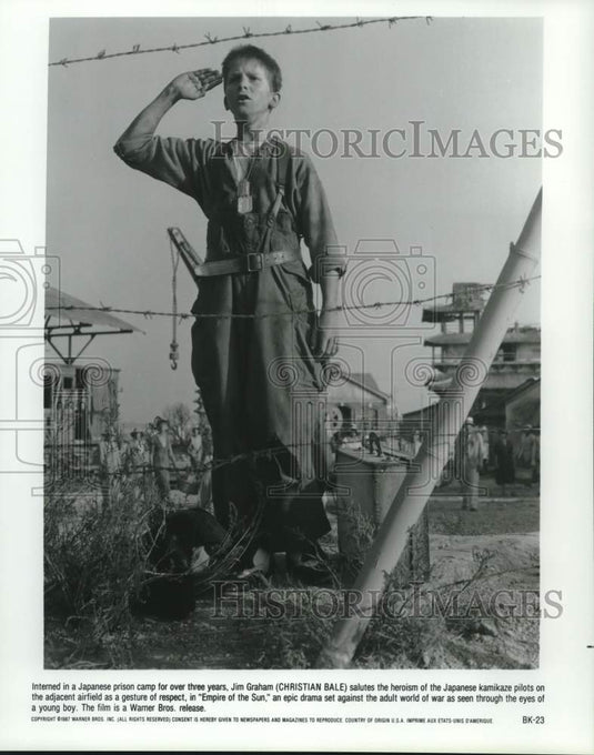 1987 Press Photo Christian Bale salutes Japanese pilots in "Empire of the Sun" - Historic Images