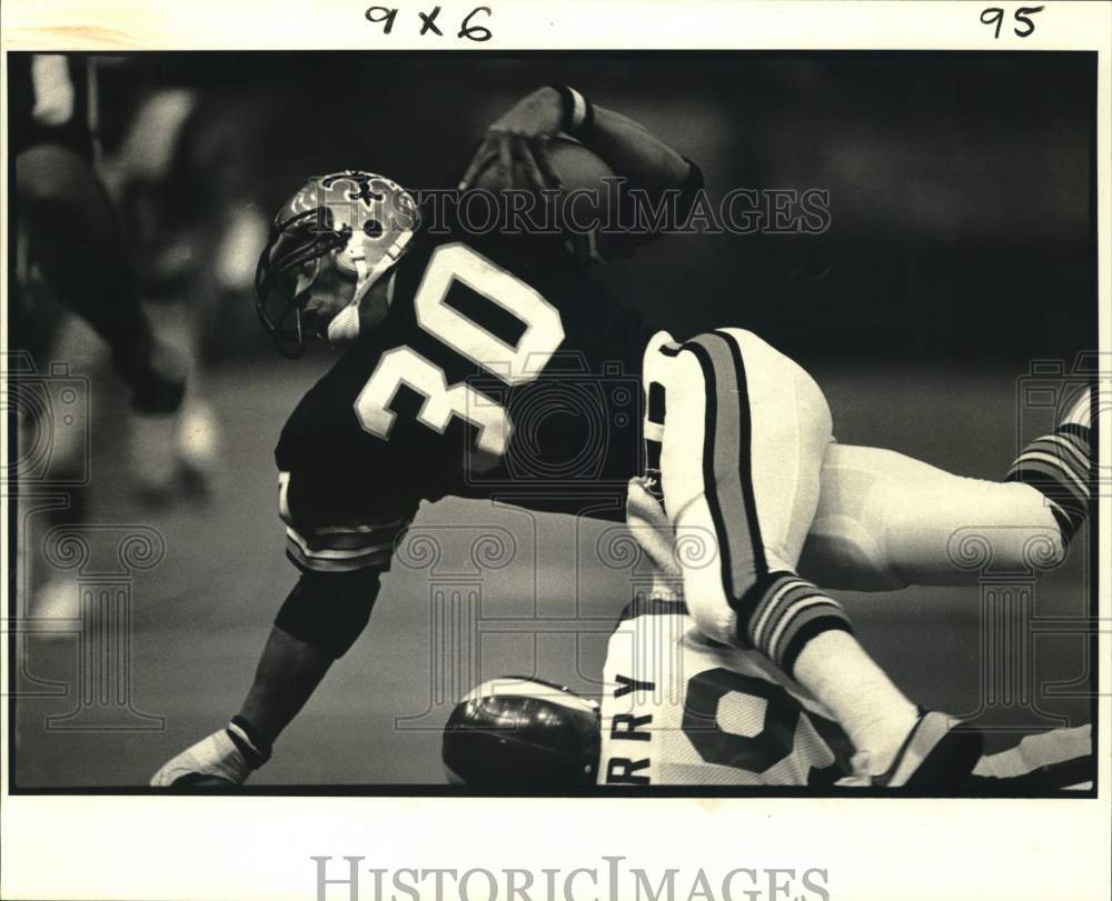 1980 Press Photo Saint Wayne Wilson Stumbles over Ram Rod Perry in Football Game- Historic Images