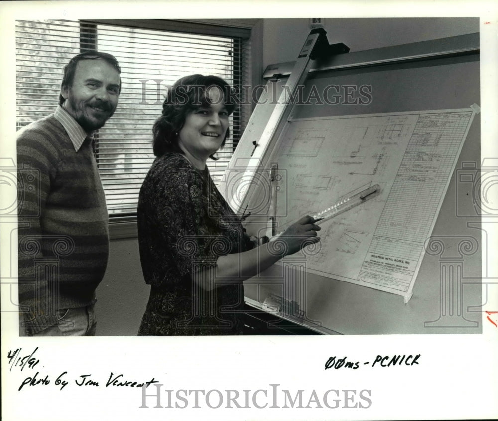 1991 Press Photo Nick and Anna Zogas look over blueprints for office and shop.- Historic Images