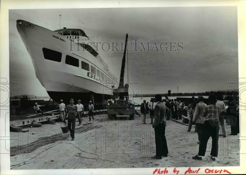 1980 Workmen help to free Glacier Queen II during launching ceremony - Historic Images