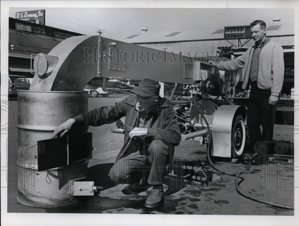 1967 Press PhotoRobin Bunker Kneels &amp; Operates Anti-Pollution Device he Invented - Historic Images