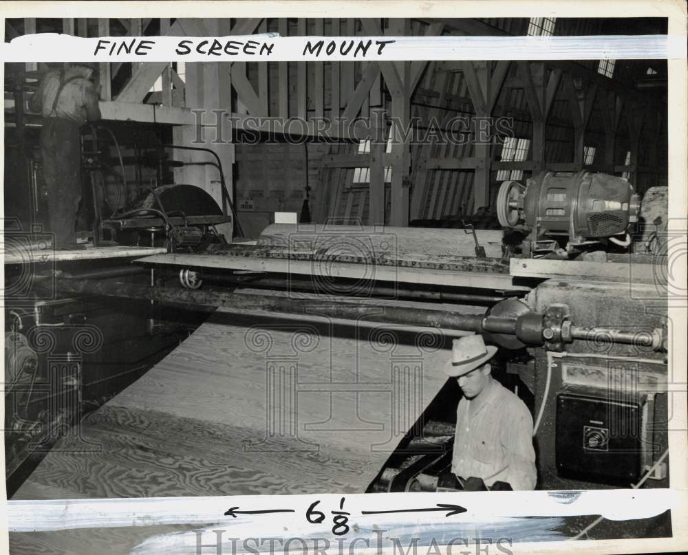 1942 Press Photo Man works on lumber with equipment - pio36949 - Historic Images
