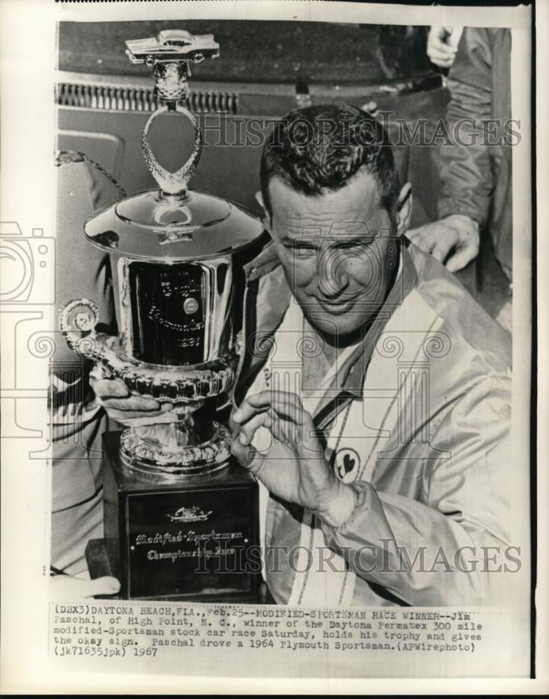 1967 Press Photo Race car driver Jim Paschal holds trophy, Daytona Beach, FL - Historic Images
