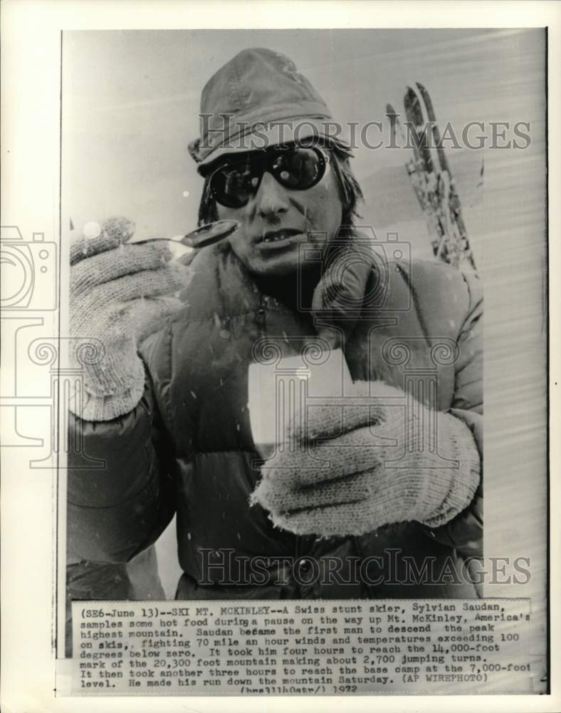 1972 Press Photo Swiss stunt skier Sylvian Saudan samples food, Mt. Mckinley - Historic Images