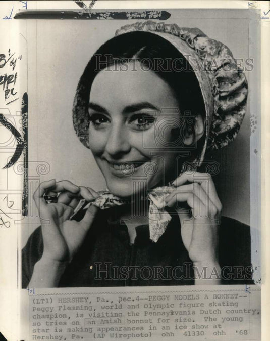1968 Press Photo Figure Skater Peggy Fleming tries on Amish bonnet, Hershey, PA - Historic Images