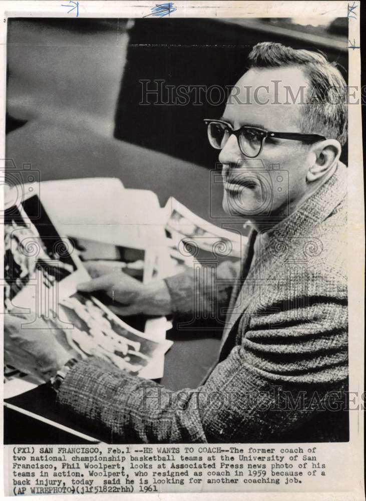 1961 Press Photo Phil Woolpert looks at Associated Press shot of his teams - Historic Images