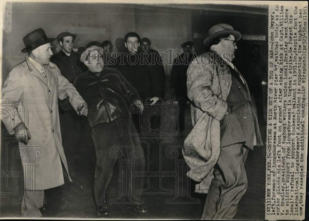 1953 Dock worker aims a kick at Captain William Bradley, NY-Historic Images