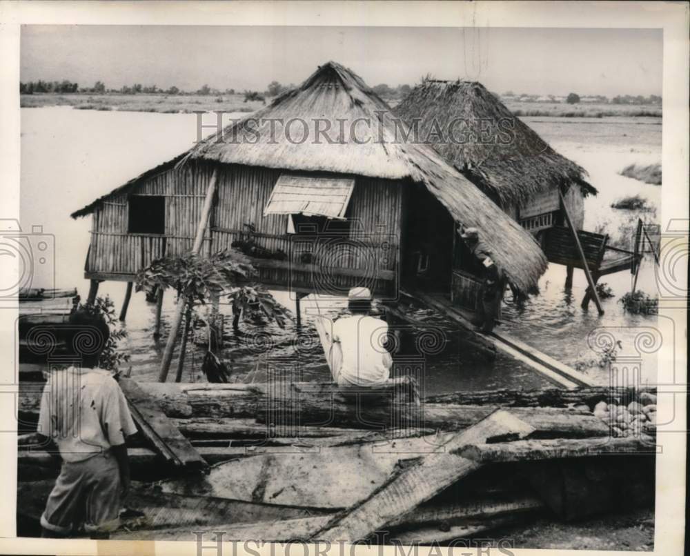 1950 People looking at flooded house in Bataan, Philippines-Historic Images