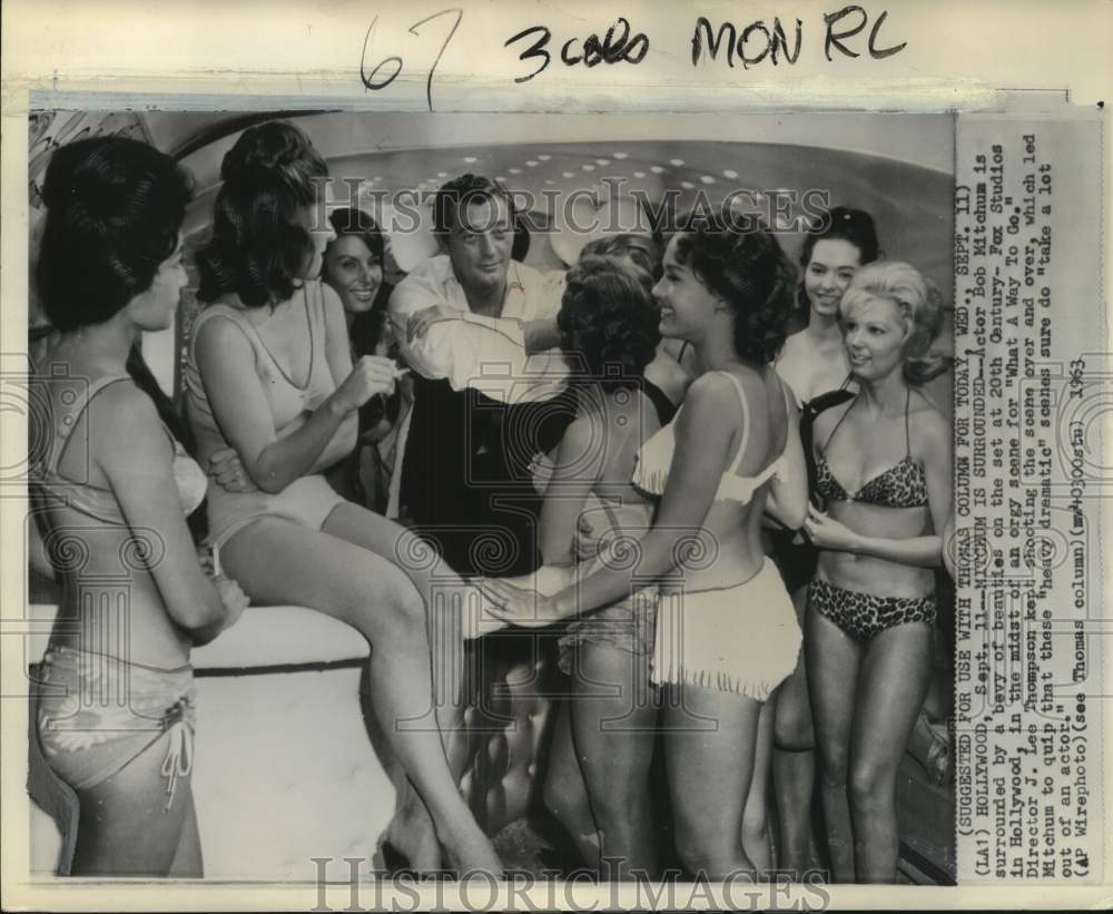 1963 Actor Bob Mitchum surrounded by women in "What a Way to Go"-Historic Images