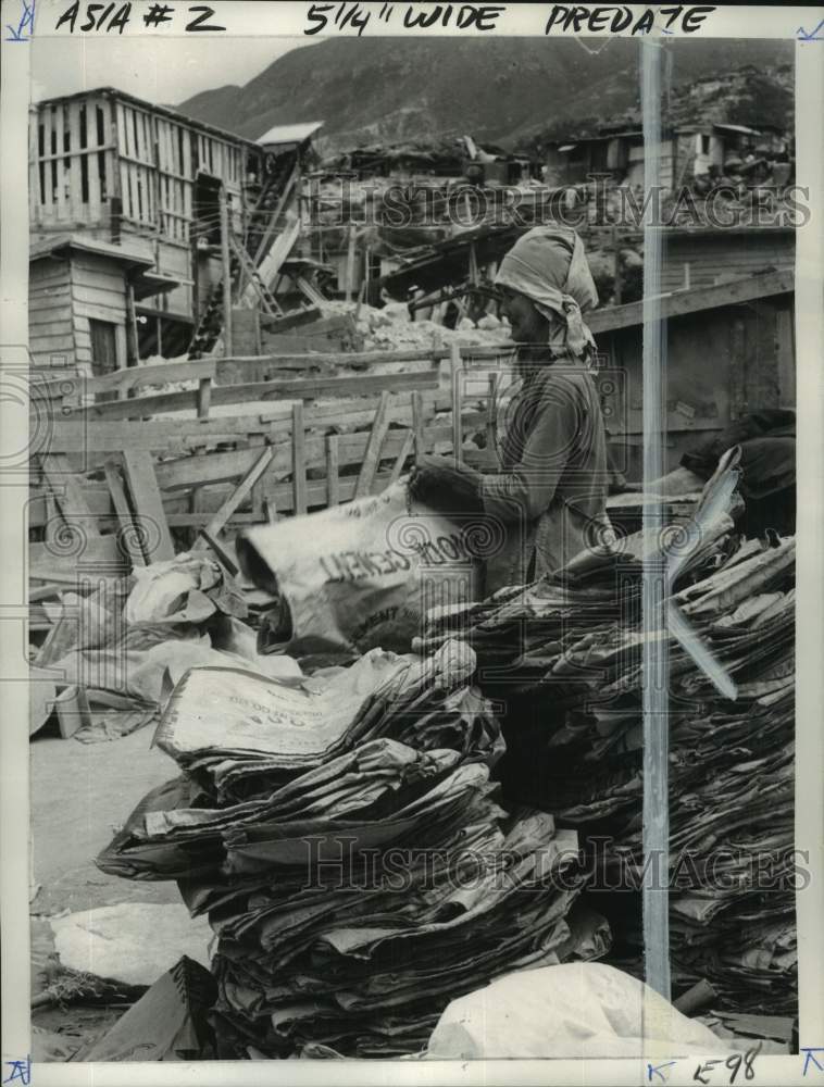 1965 Chang Yauping cleans used paper cement bags in Hong Kong-Historic Images