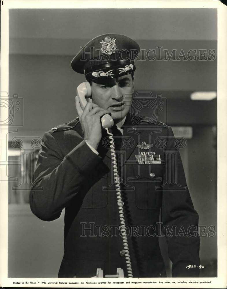 1963 Actor Rock Hudson on phone in military officer costume-Historic Images