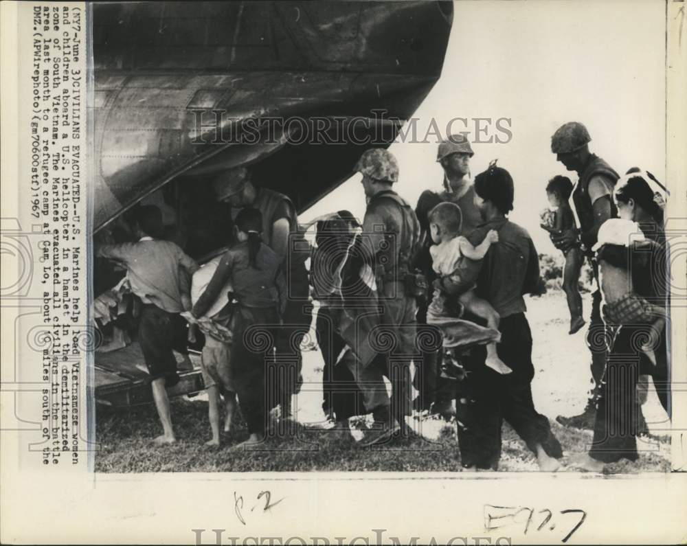 1967 US Marines load Vietnamese women &amp; children aboard helicopter - Historic Images