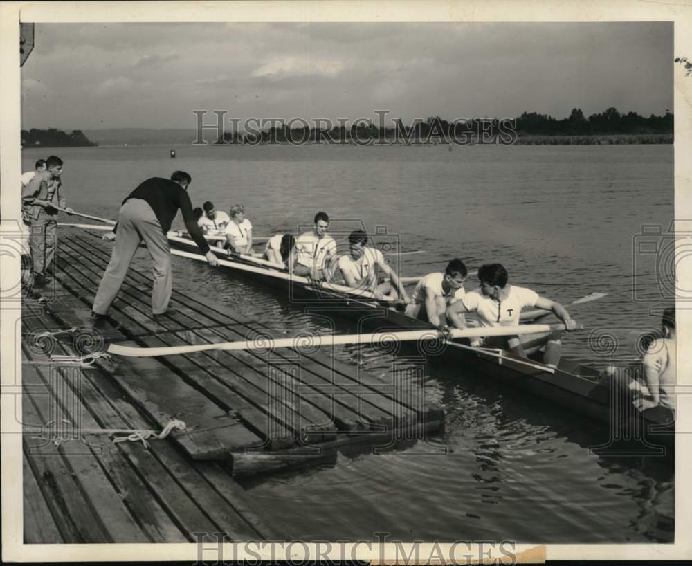 Press Photo Coach Jim McMillin pushes out boat of M.I.T. crew to water, Seattle - Historic Images