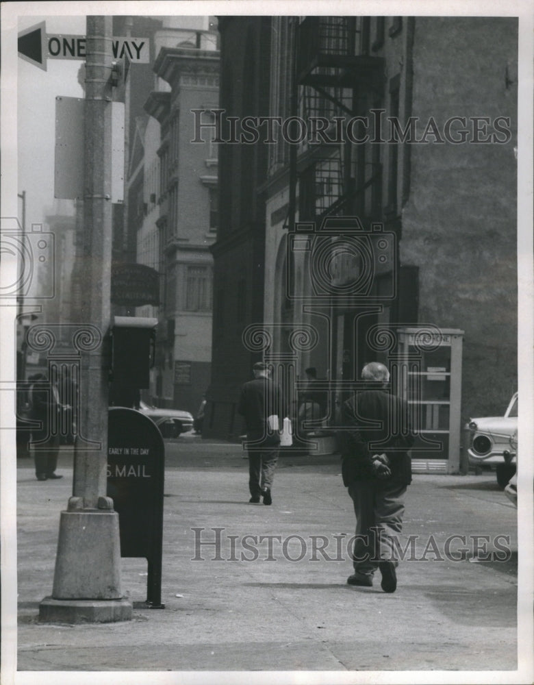1963 Elderly Man Walking Alone Down Street - Historic Images
