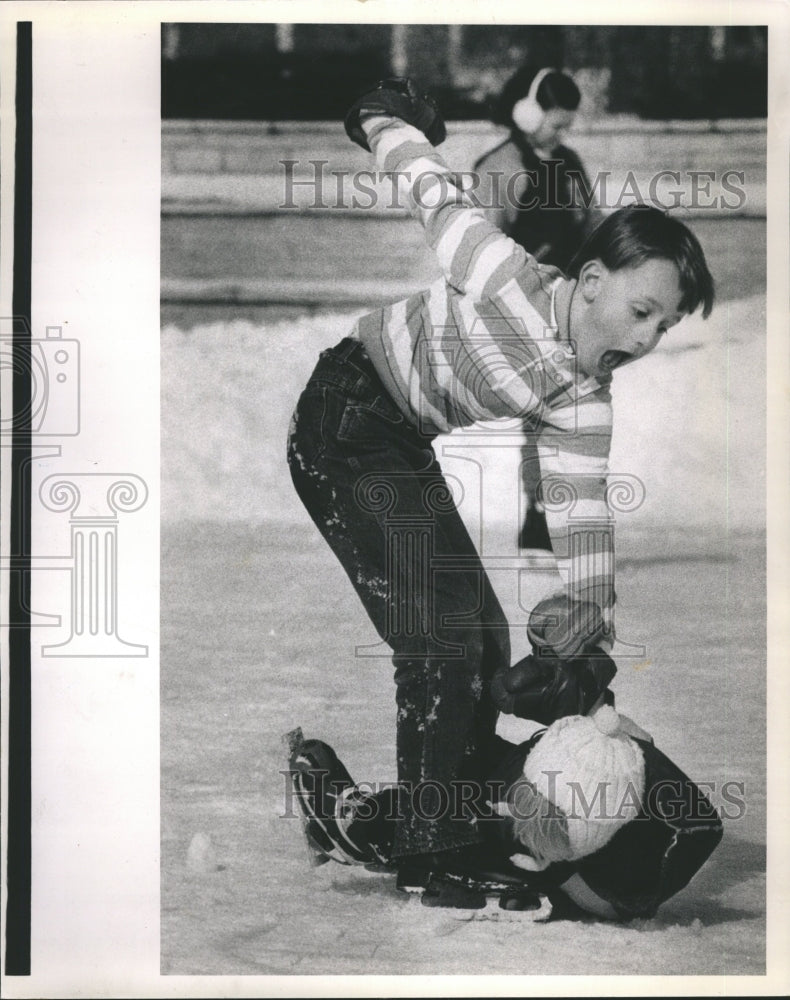 1989 Teaching Baby Brother Ice Skating - Historic Images