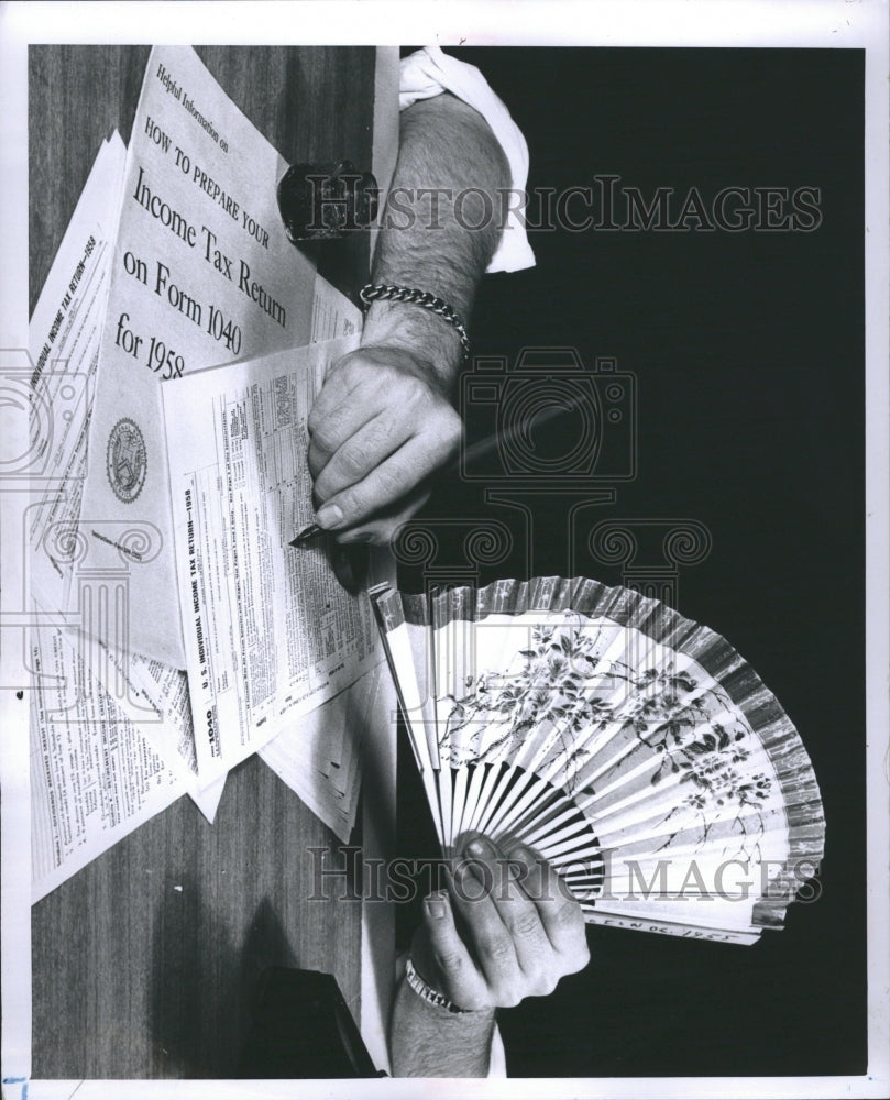 1959 Keeping Cool while filing taxes - Historic Images