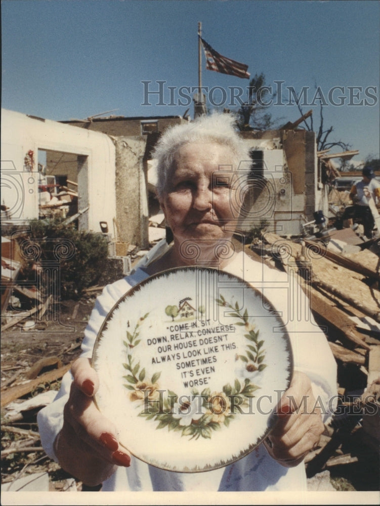 1990 a woman standing in the ruins of house - Historic Images