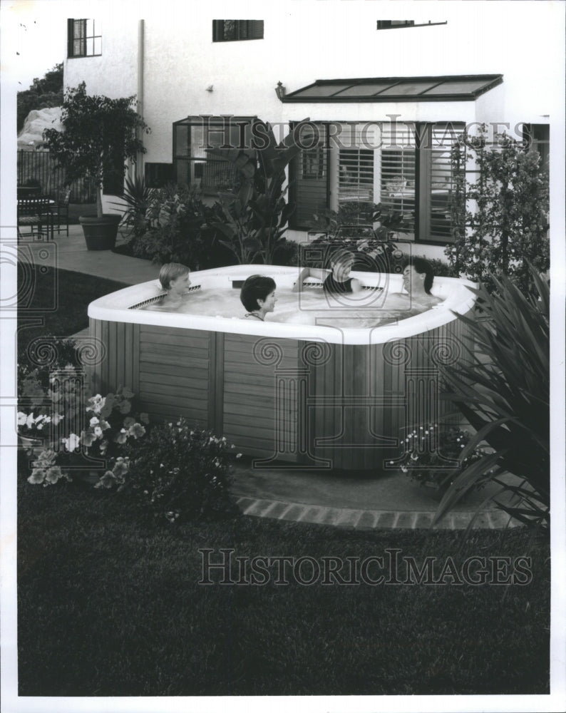 1992 family enjoying Jacuzzi - Historic Images