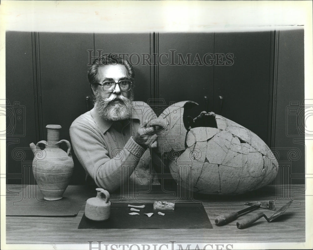 1985 Kenneth Mull shows infant burial jar - Historic Images