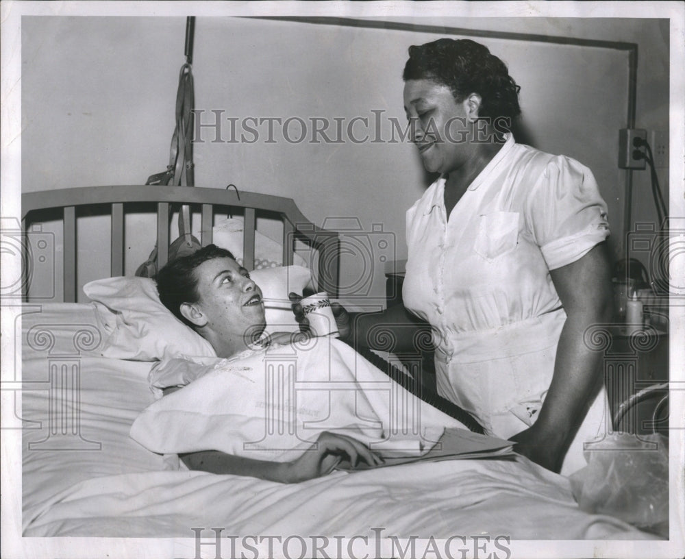 1953 Adam Tanceusz attends to polio victim  - Historic Images