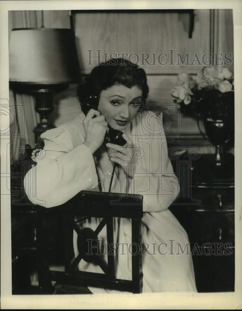 1943 Actress Katharine Cornell converses on phone in movie scene - Historic Images