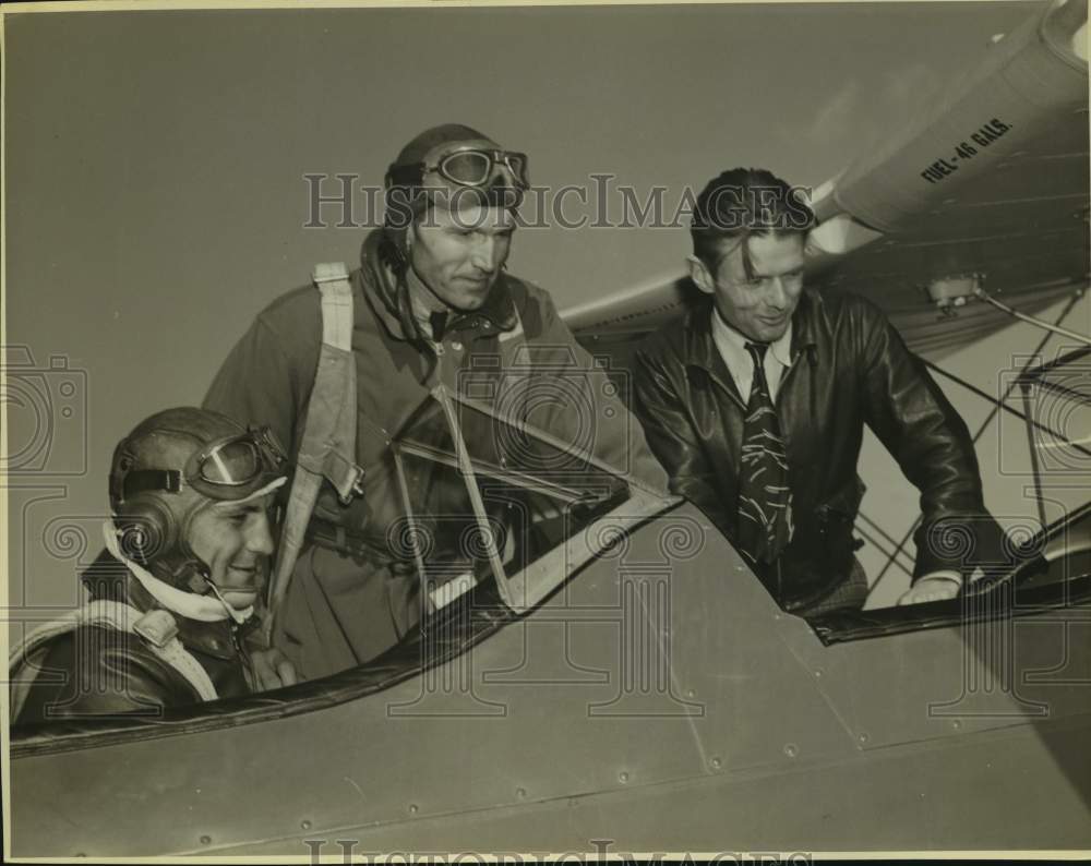 Douglas Corrigan at Randolf Field in plane with two men - Historic Images