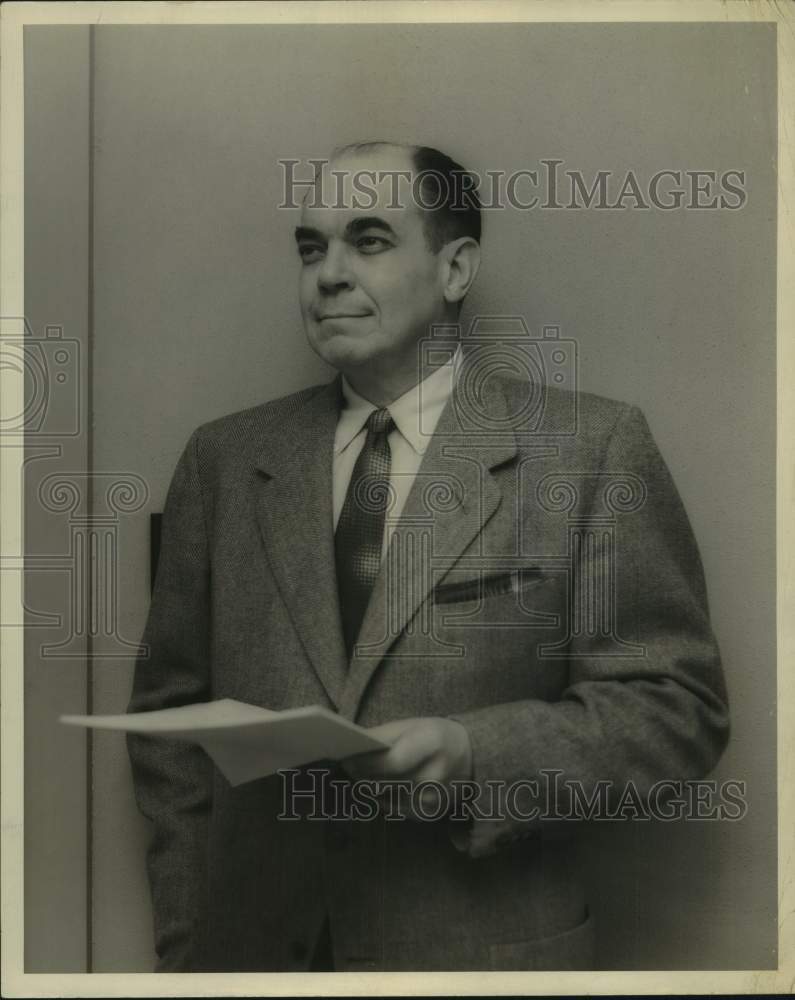 1957 Press Photo George W. Clarke smiles with paperwork in hand - Historic Images