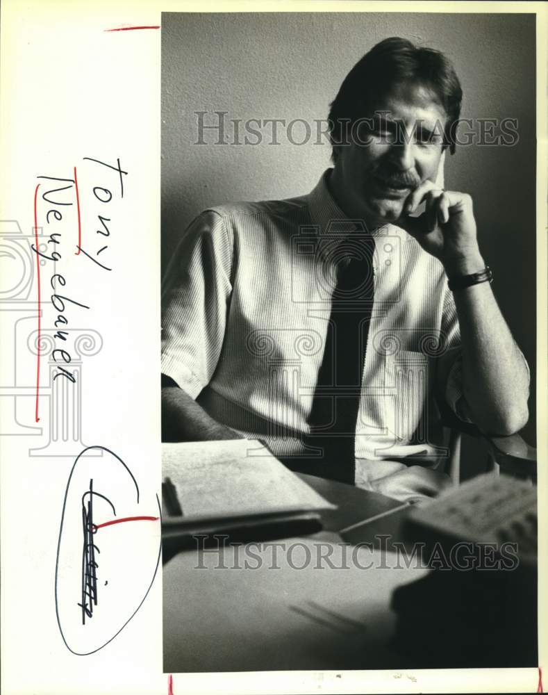 Tony Neugebauer sitting at his desk - Historic Images