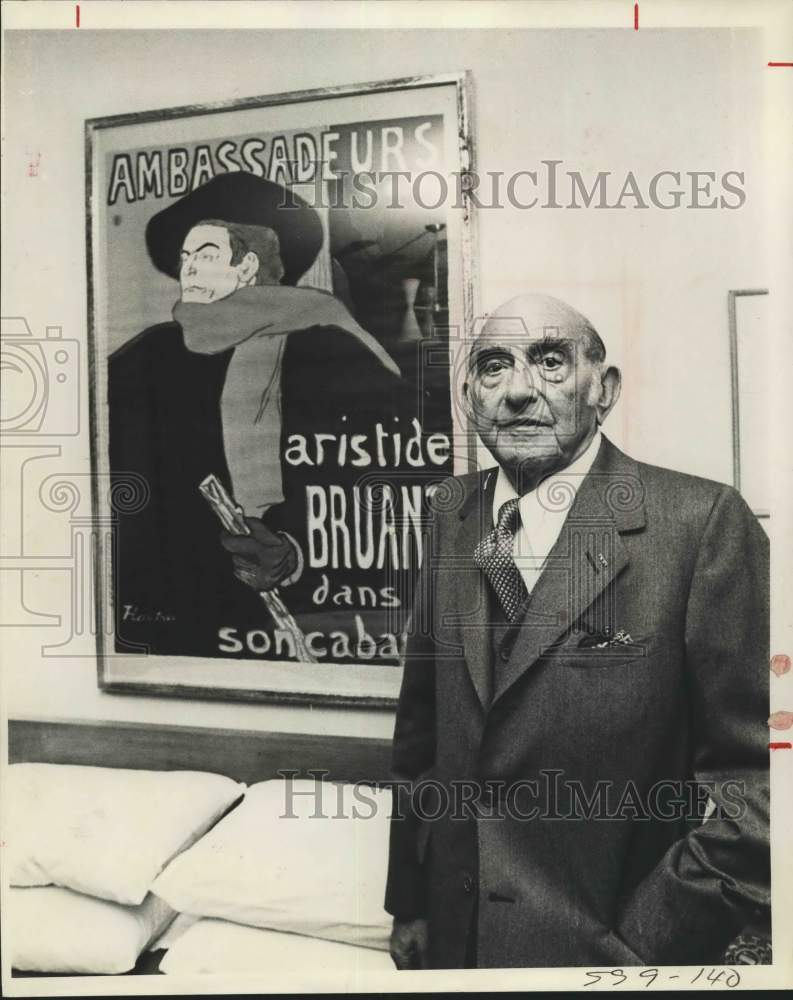 1973 Sylvan Lang, McNay Benefactor, standing in front of poster - Historic Images