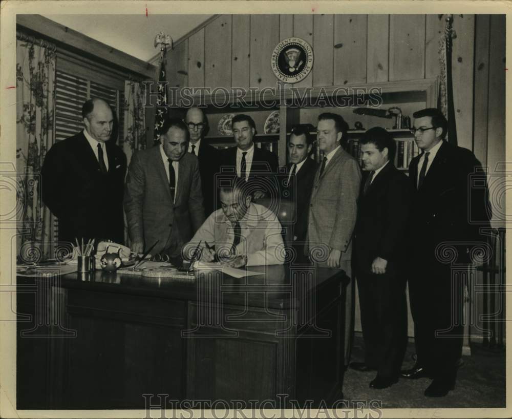 1965 Gentlemen watching President Johnson signing papers, Texas-Historic Images