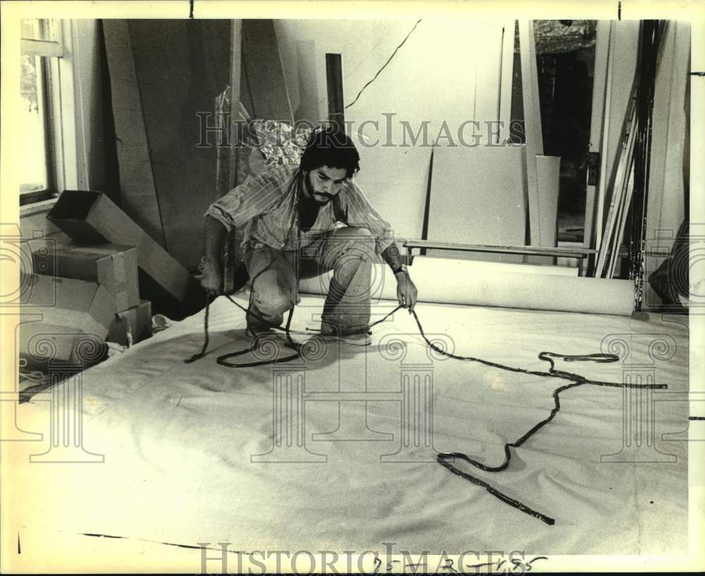 1979 Artist Robert Gonzalez prepares painting for exhibit, Texas-Historic Images