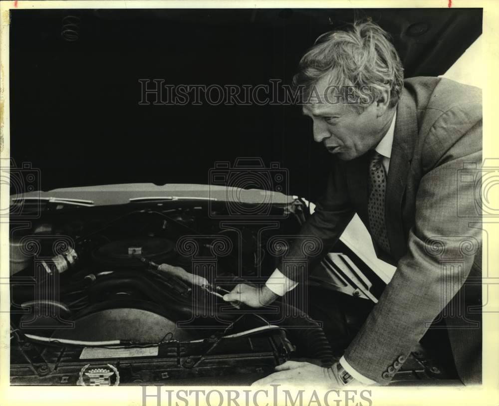 1984 Richard Goranflo looks at engine in his 1977 Cadillac, Texas-Historic Images