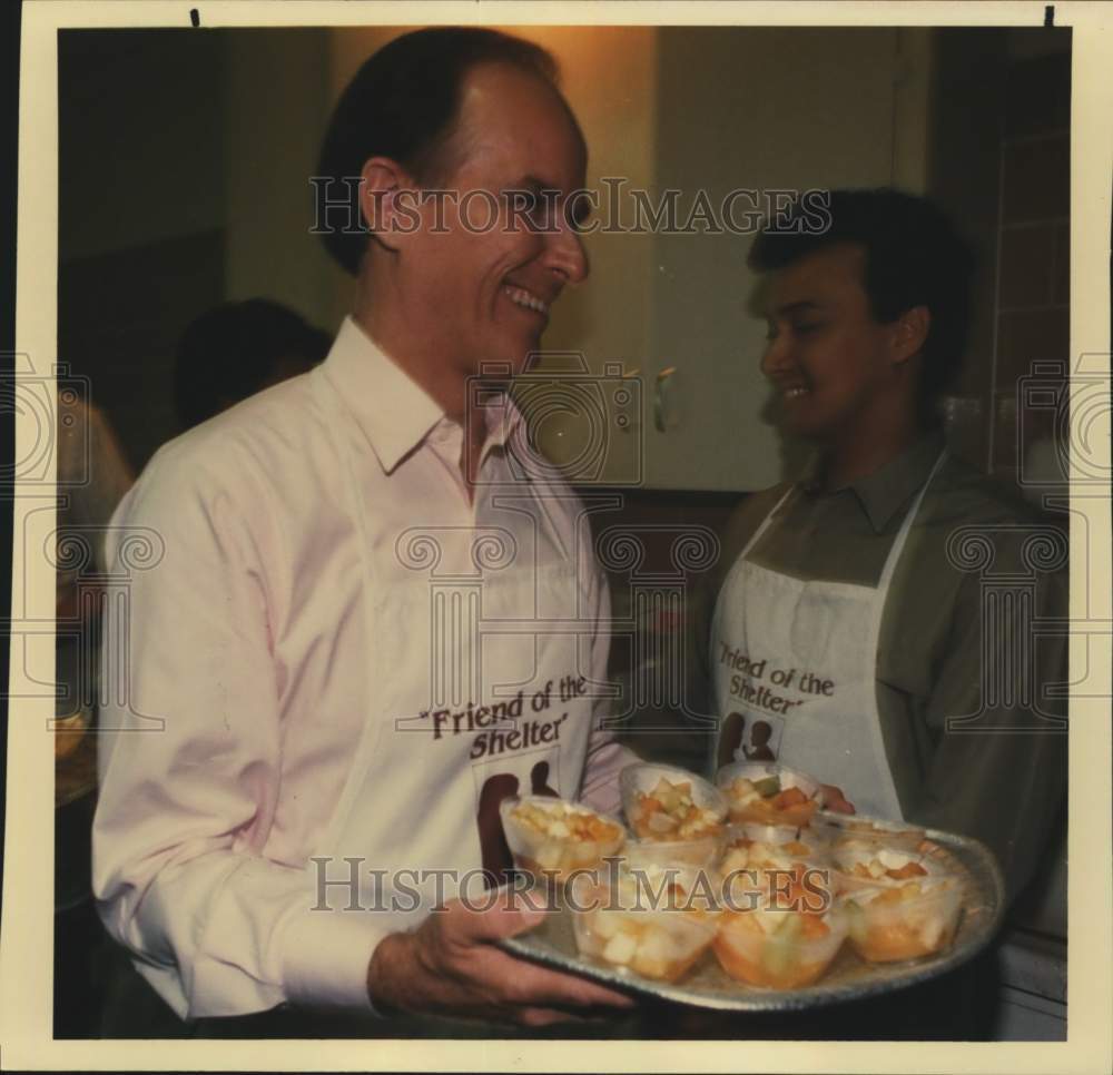 1991 Nelson Wolff serving food at the Archbishop's breakfast, Texas-Historic Images