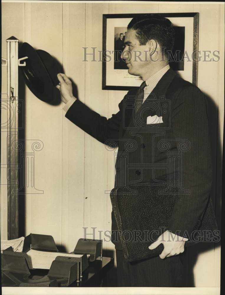 Lin Harwood hanging his hat on hook-Historic Images
