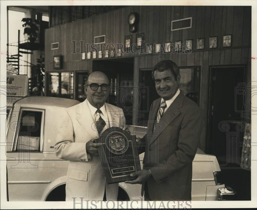 1978 C. C. &quot;Pop&quot; Gunn, auto dealer, and gentleman holding award-Historic Images