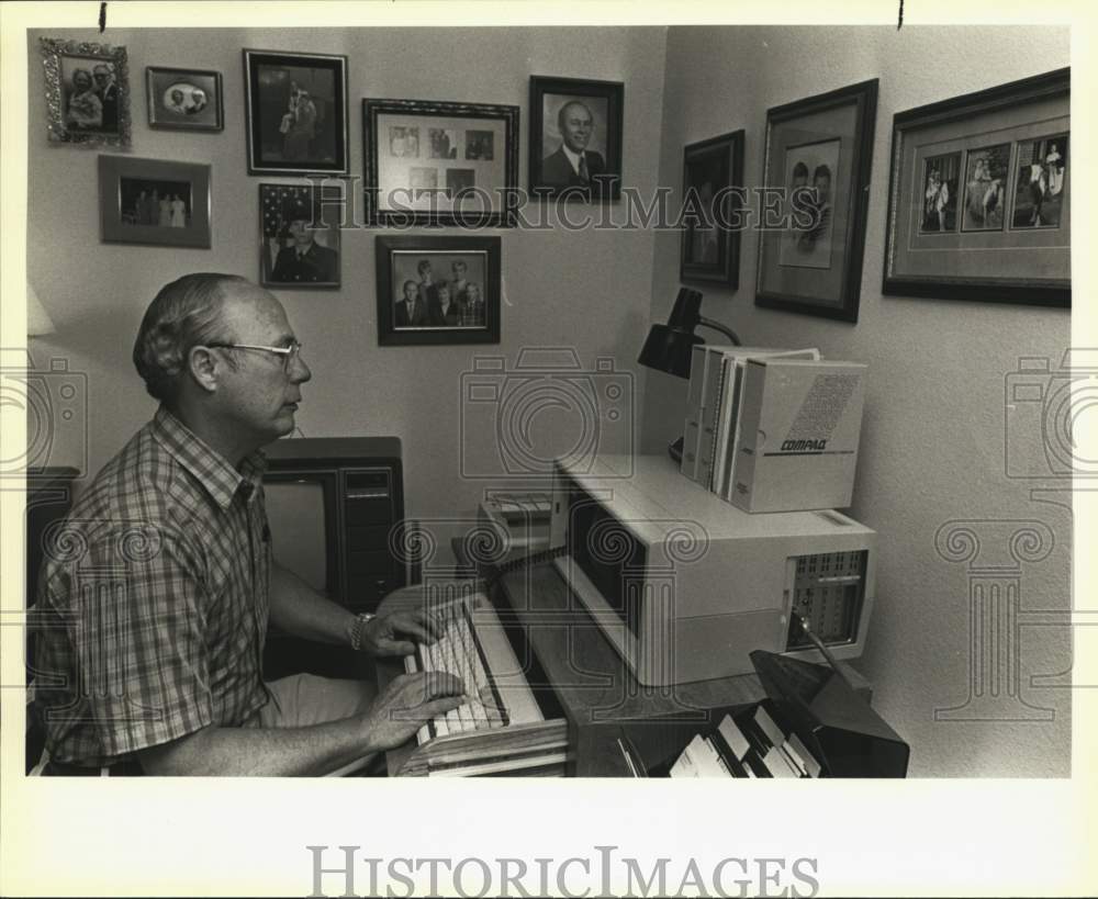 1985 Ed Harrington working at a portable computer, Texas - Historic Images