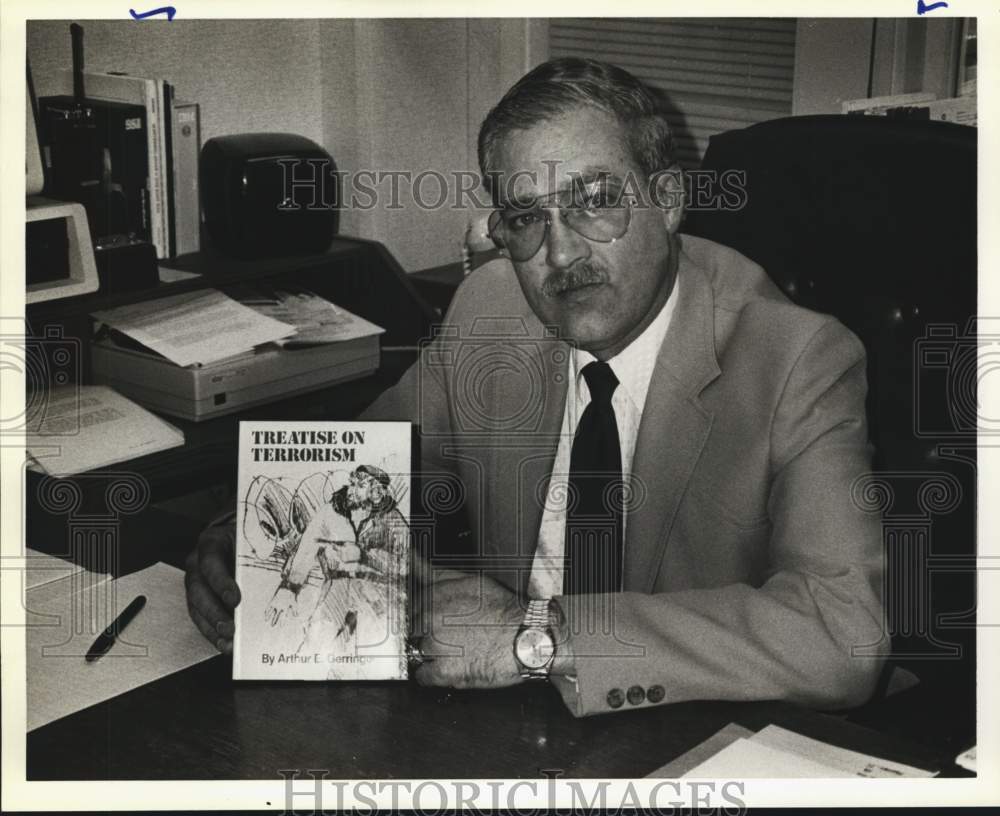 1991 Author Arthur E. Gerringer holding his book on terrorism, Texas-Historic Images