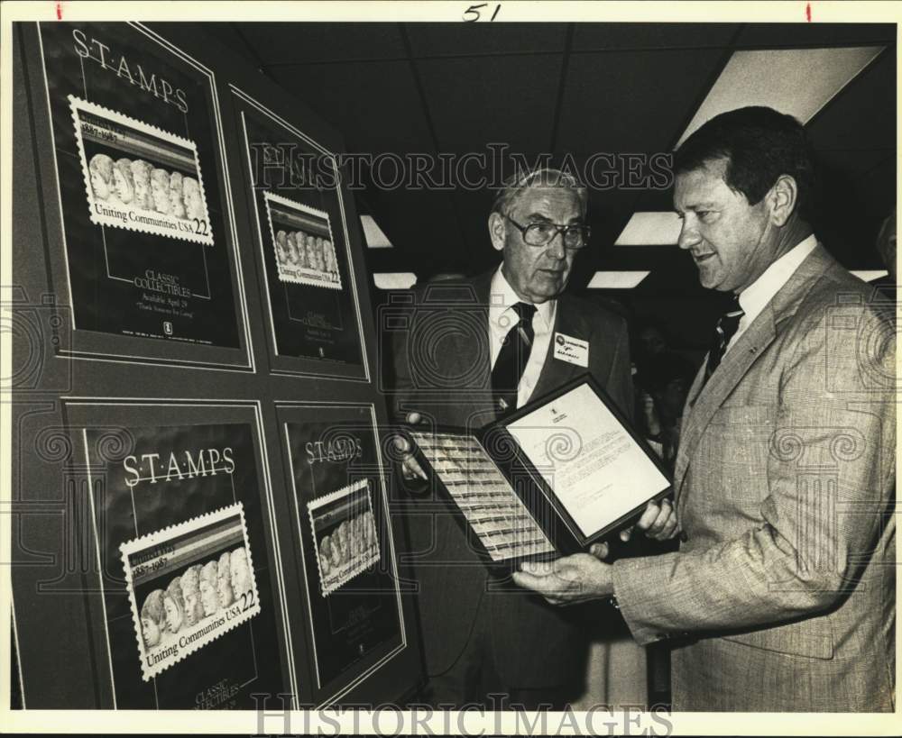 1987 Bill Greehey and Joe Schraer viewing United Way Stamps, Texas-Historic Images