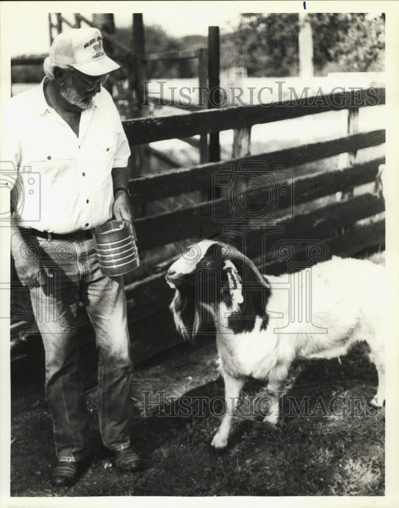 1993 West Texas Ranger W.E. Whitehead Feeds Boer Goat In Pen-Historic Images