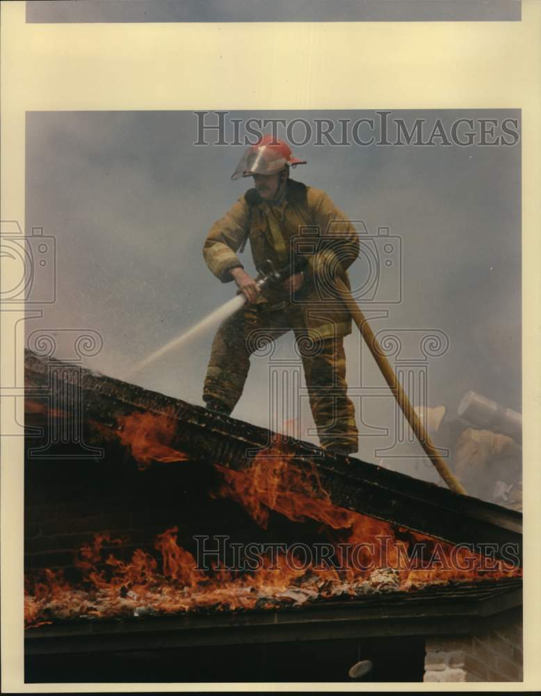 1988 Leon Valley Fireman battles fire, Forest Oaks Apartments, Texas-Historic Images